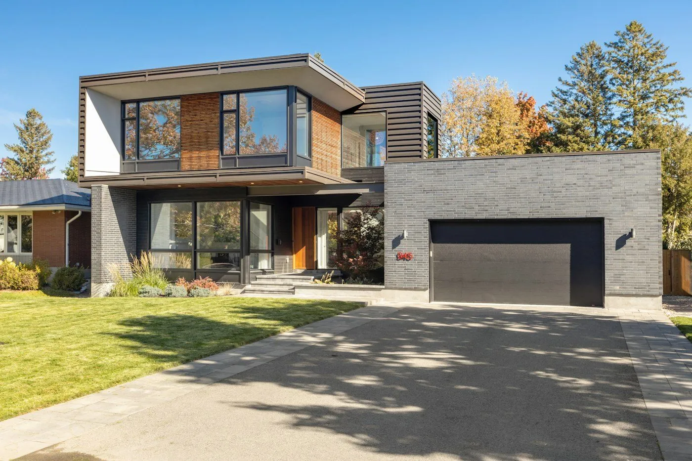 Modern Sandy Springs-style home with a finished concrete driveway and garage apron